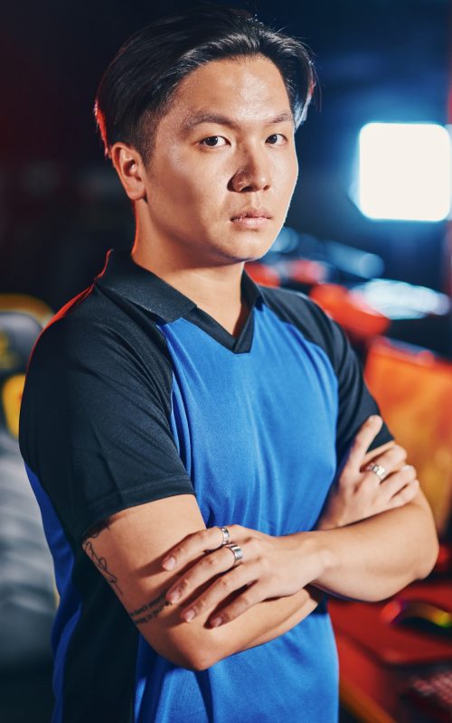 vertical-shot-of-young-asian-guy-male-cyber-sport-gamer-keeping-arms-crossed-and-looking-at-camera.jpg